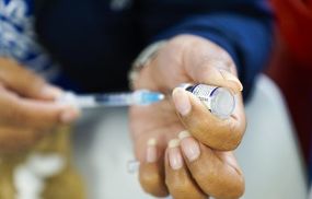 A health worker prepares Pfizer COVID-19 vaccine on March 22, 2022 in San Salvador, El Salvador. El Salvador begun the application of a fourth dose of the COVID-19 vaccine.