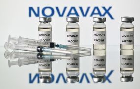 An illustration picture shows vials with Covid-19 Vaccine stickers attached and syringes with the logo of US biotech company Novavax, on November 17, 2020.