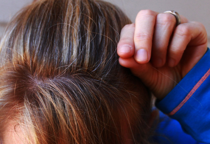 Woman plucking grey hair 