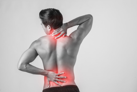 A man feeling neck and lower back pain