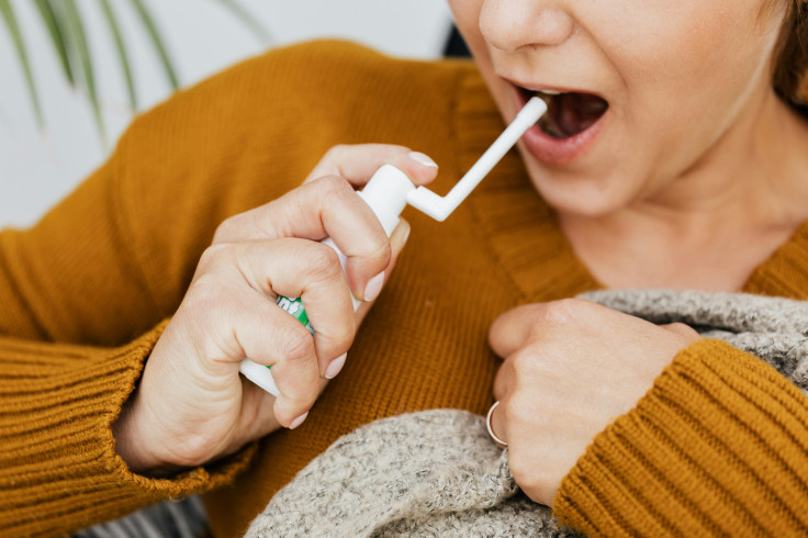 Woman Using a Medicine Mouth Spray