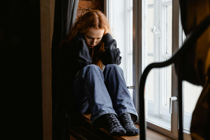 Depressed Woman Sitting by the Window