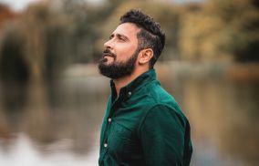 Man Standing Near a Body of Water