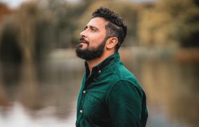 Man Standing Near a Body of Water