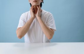 Man puting his Hands on his Neck