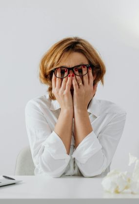 Woman Looking Stressed Sitting at a Table