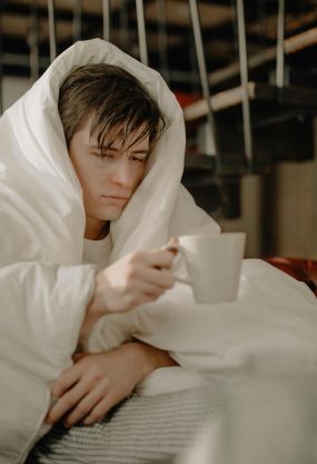 Sick Person Sitting on Couch