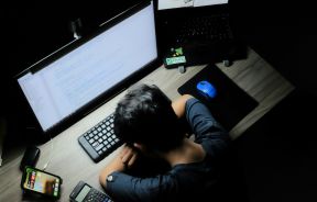 Person Laying Head Down in Front of Computer