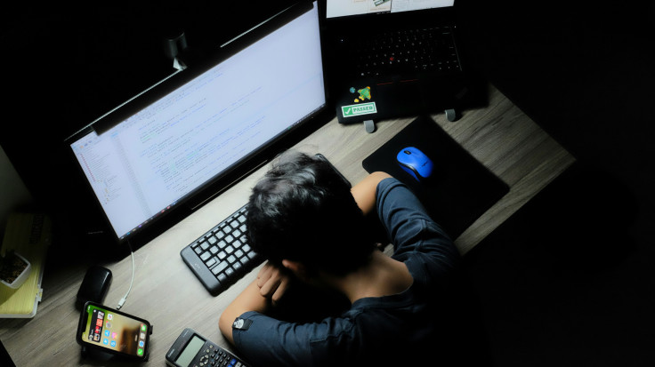 Person Laying Head Down in Front of Computer
