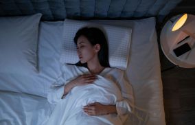 Woman Sleeping on a Bed