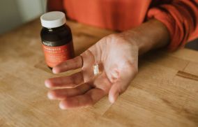 Person Holding Probiotic Supplement
